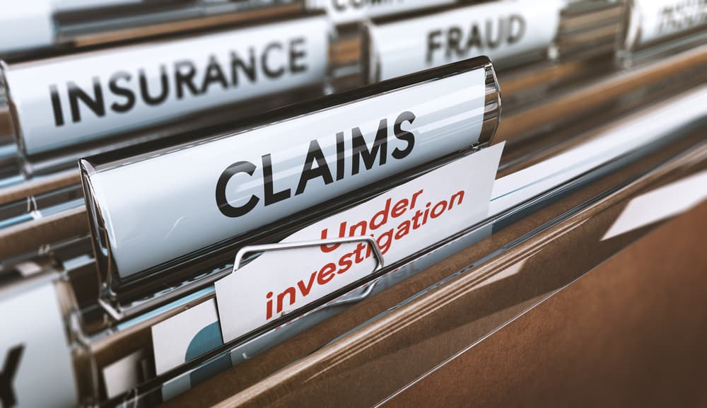 3D illustration that claims folder with 'Under Investigation' note, depicting insurance fraud claim.