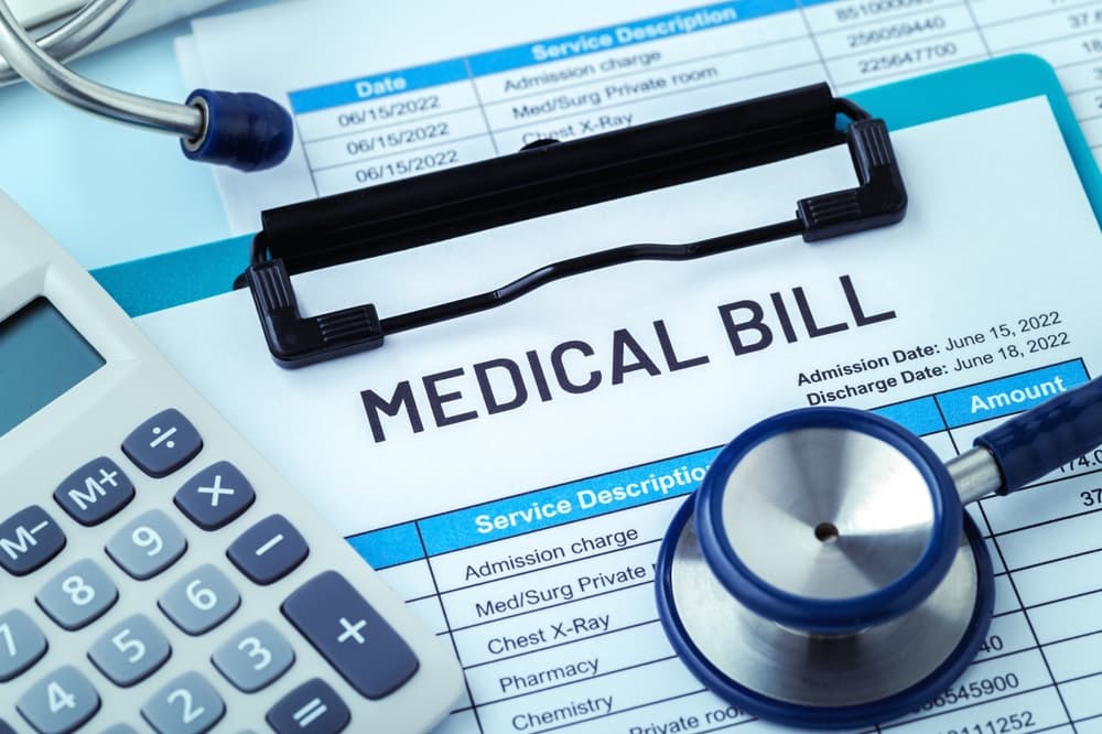 Medical Bill statement, stethoscope and calculator