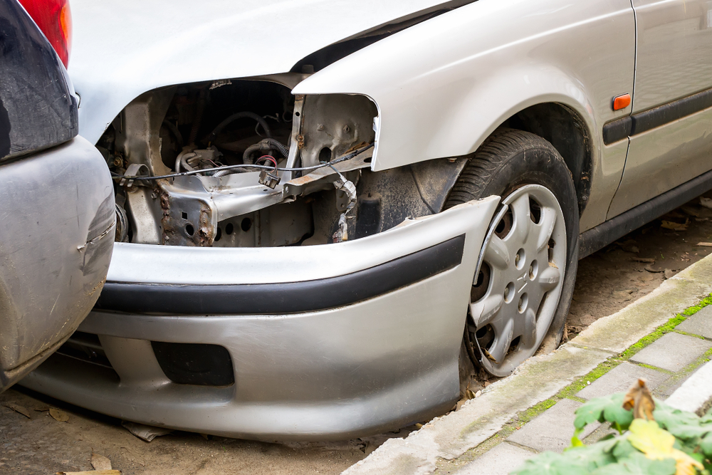Close-up of front-end vehicle damage after a low-speed collision, illustrating how minor accidents can cause hidden structural issues.