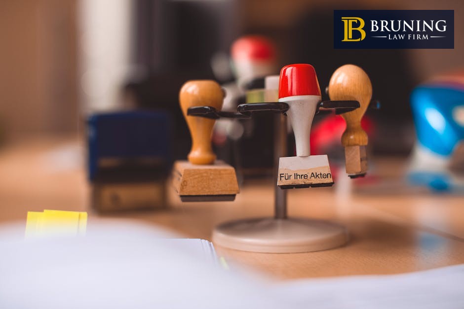 Rubber stamps on a wooden table representing workers compensation claim decisions