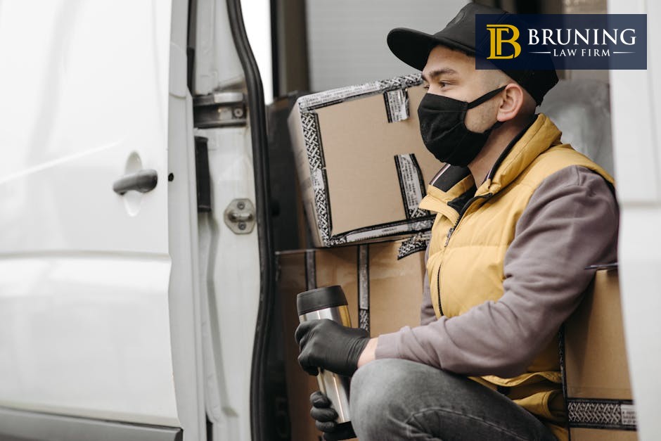 Delivery man sitting in van with packages representing independent contractor work
