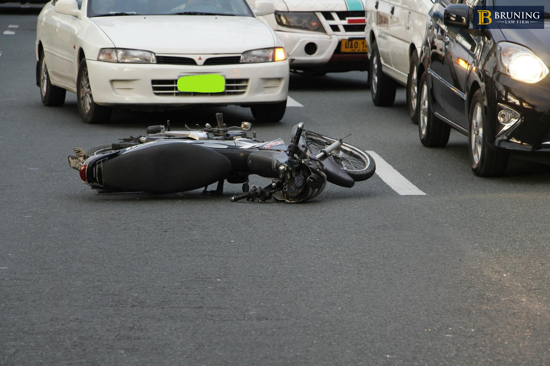 Motorcycle lying on road after an accident showing common causes of motorcycle crashes