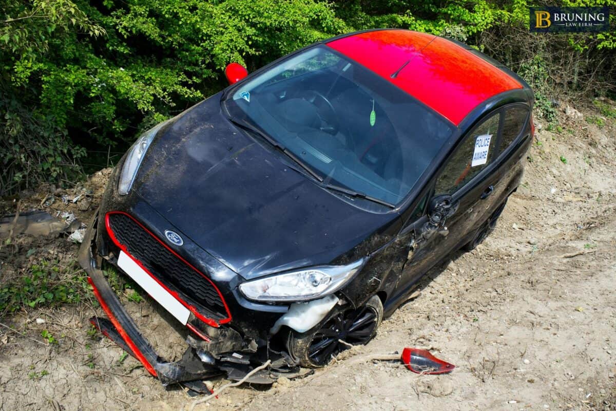 Person holding their head in pain after hitting their head in a car accident