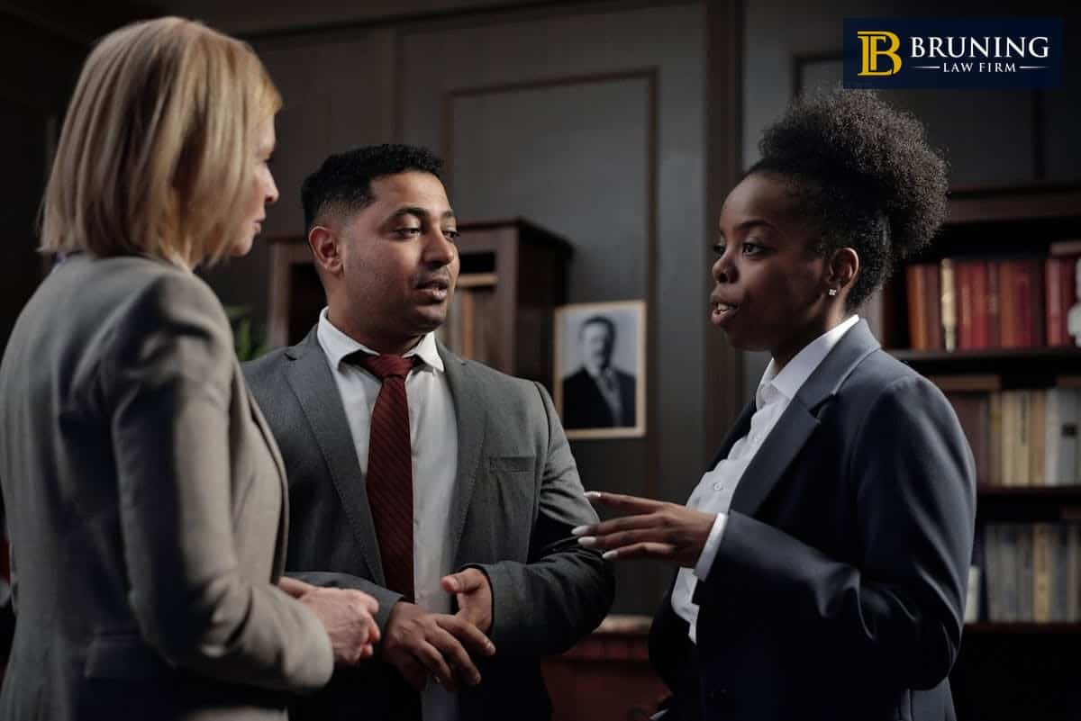Personal injury lawyers discussing case details with a client in an office.